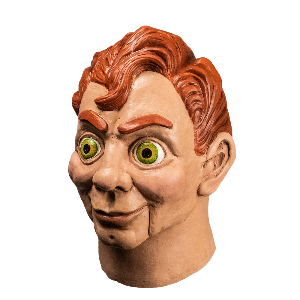 Ventriloquist dummy mask left side view. Head and neck. Red hair and eyebrows, large yellow green eyes