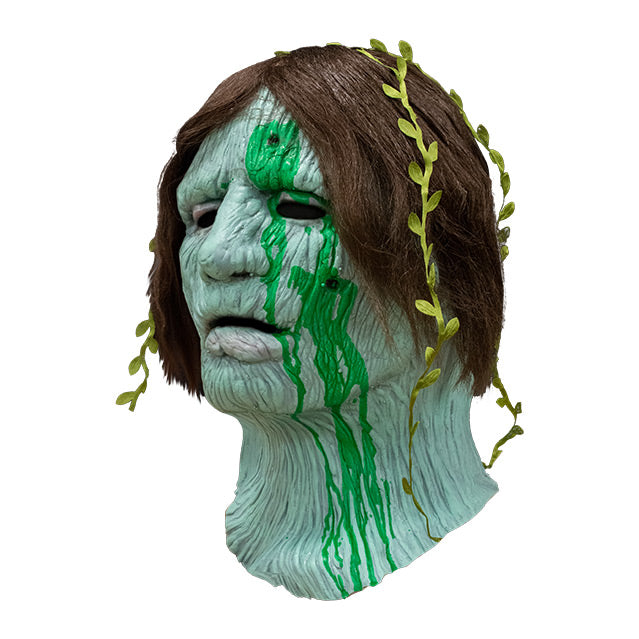 left side view, Creepshow Harry Mask, Zagone Edition. Head and neck of man. Red brown straight hair, with seaweed in it, green wrinkled mossy skin, eyes appear closed. hole in forehead and left cheek oozing dried green fluid.