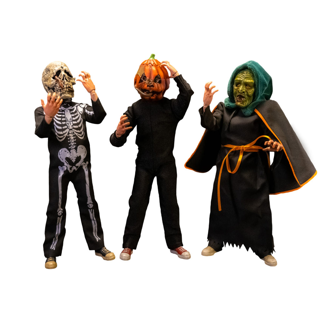 Three 1/6 scale figures and accessories. Figure in skeleton costume, figure in jack o' lantern costume, figure in witch costume. wearing spooky rotting heads.