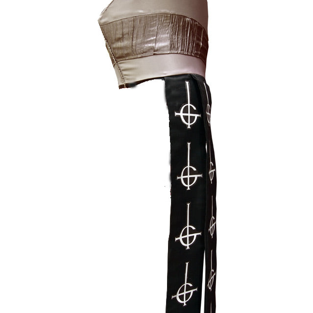 Back side view. Black and silver, tall hat  Black sashes hanging from hat, adorned with repeating inverted crosses, with semi circle that looks like a G. 