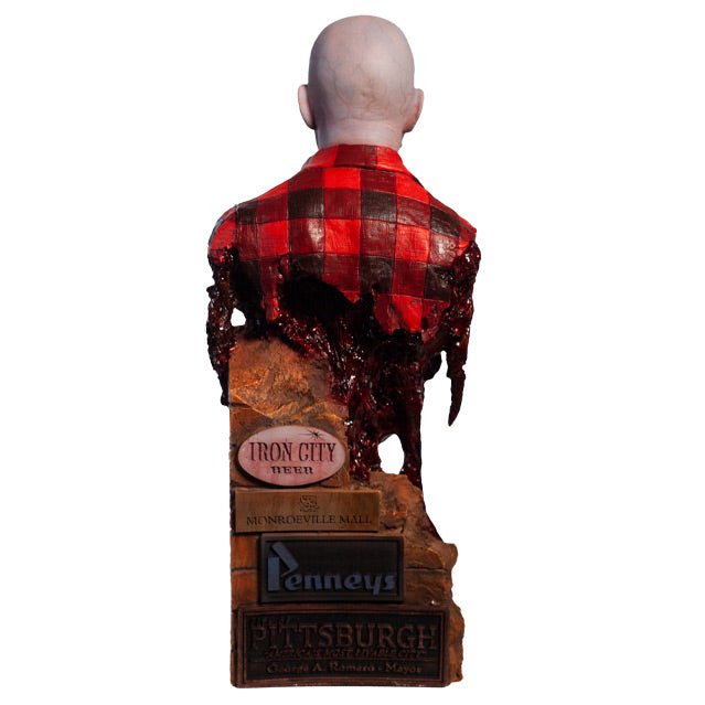 Back view. Airport Zombie bust. Head shoulders and upper torso. Bald zombie, wearing torn red and black flannel shirt, with gore hanging from shoulders and back. Base of bust is a broken brick wall, Signs at bottom.
