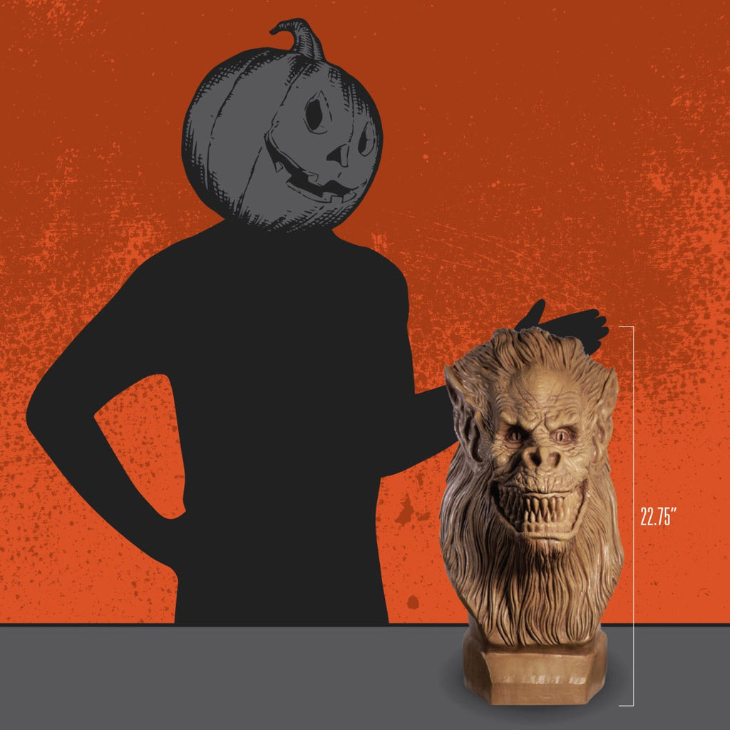 Orange background.  Person in all black with Jack o' lantern head showing the height of the bust.  22.75 inches.