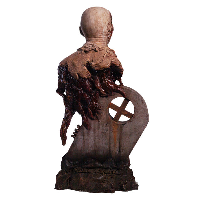 Bust, back view. Rotted zombie head neck and upper torso, wearing dirty rotted torn clothing. Gore around shoulders, bottom of torso and back. Base is gravestone set in soil, with zombie arm coming from the ground.