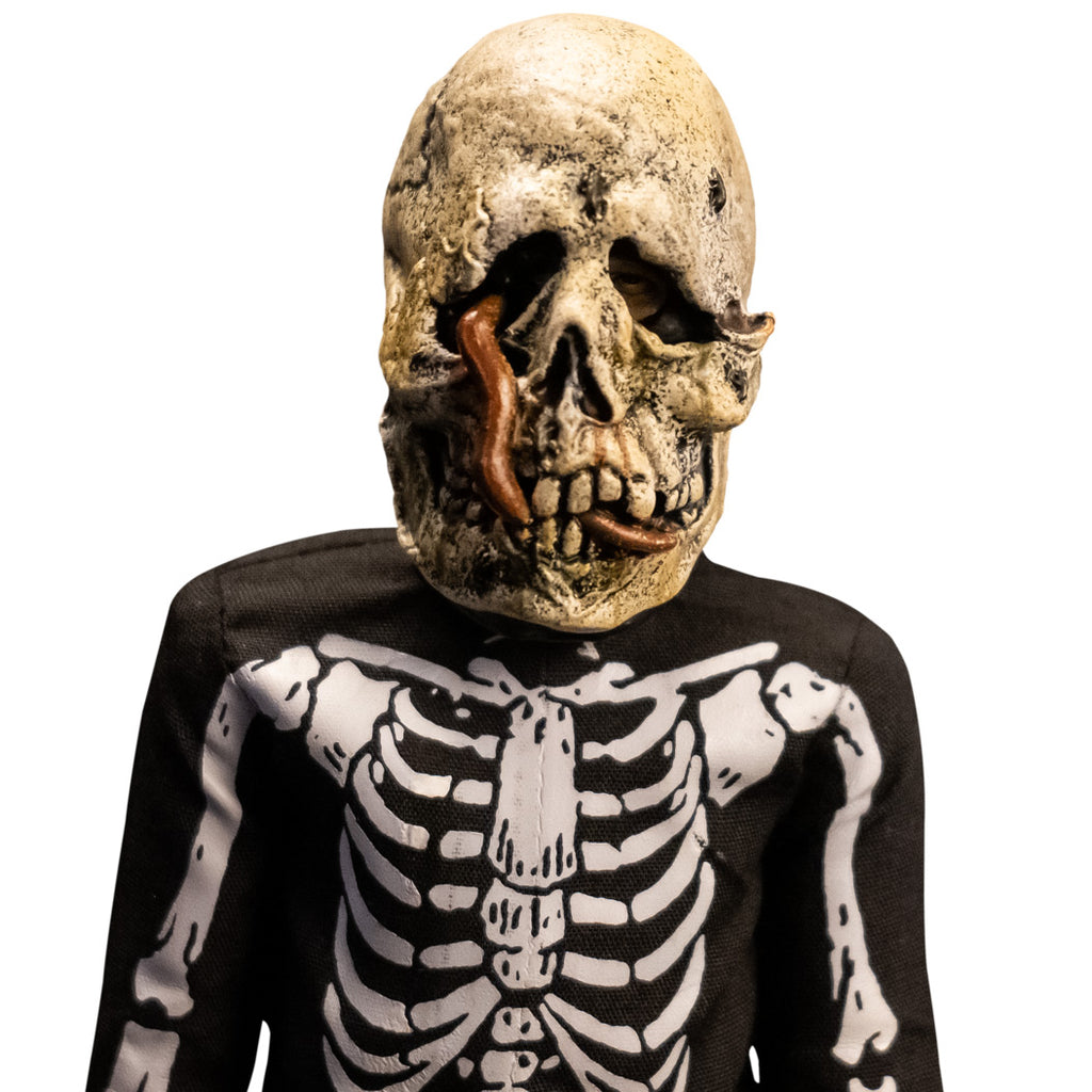 Close up of head and shoulders of skeleton costume figure. White and black rotting skull mask with worms coming out, wearing black and white skeleton coveralls.