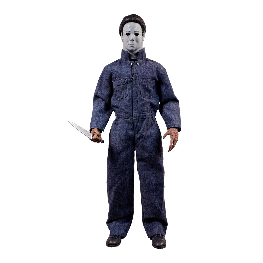 Front view. Halloween 4 Michael Myers 12" figure. White mask brown hair, wearing blue coveralls, black boots, holding butcher knife in right hand.