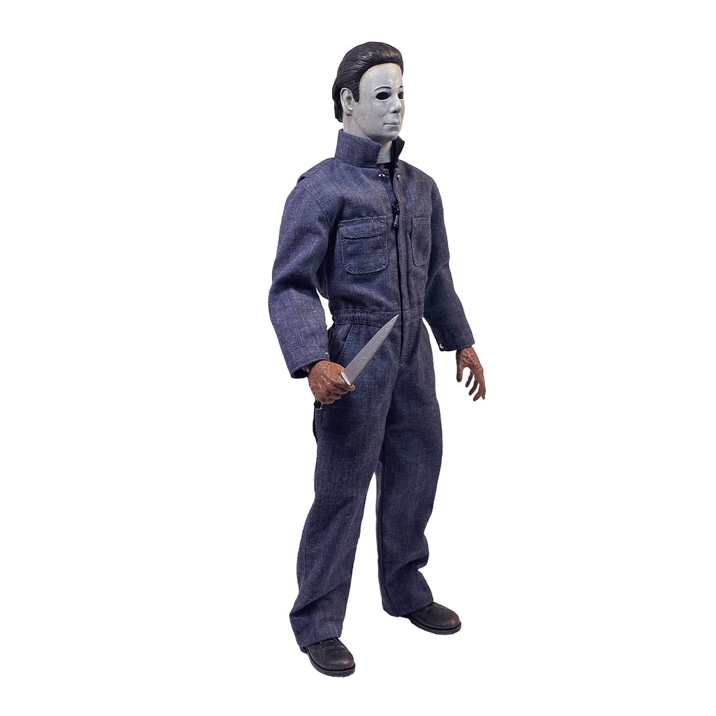 Right side view. Halloween 4 Michael Myers 12" figure. White mask brown hair, wearing blue coveralls, black boots, holding butcher knife in right hand.