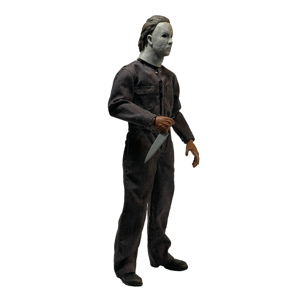 Right side view. Halloween 5 Michael Myers 12" figure. White mask brown hair, wearing coveralls, black boots, holding butcher knife in right hand.