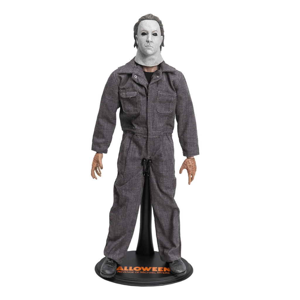 Front view. Halloween 5 Michael Myers 12" figure. White mask brown hair, wearing coveralls, black boots, set on Halloween 5 figure stand