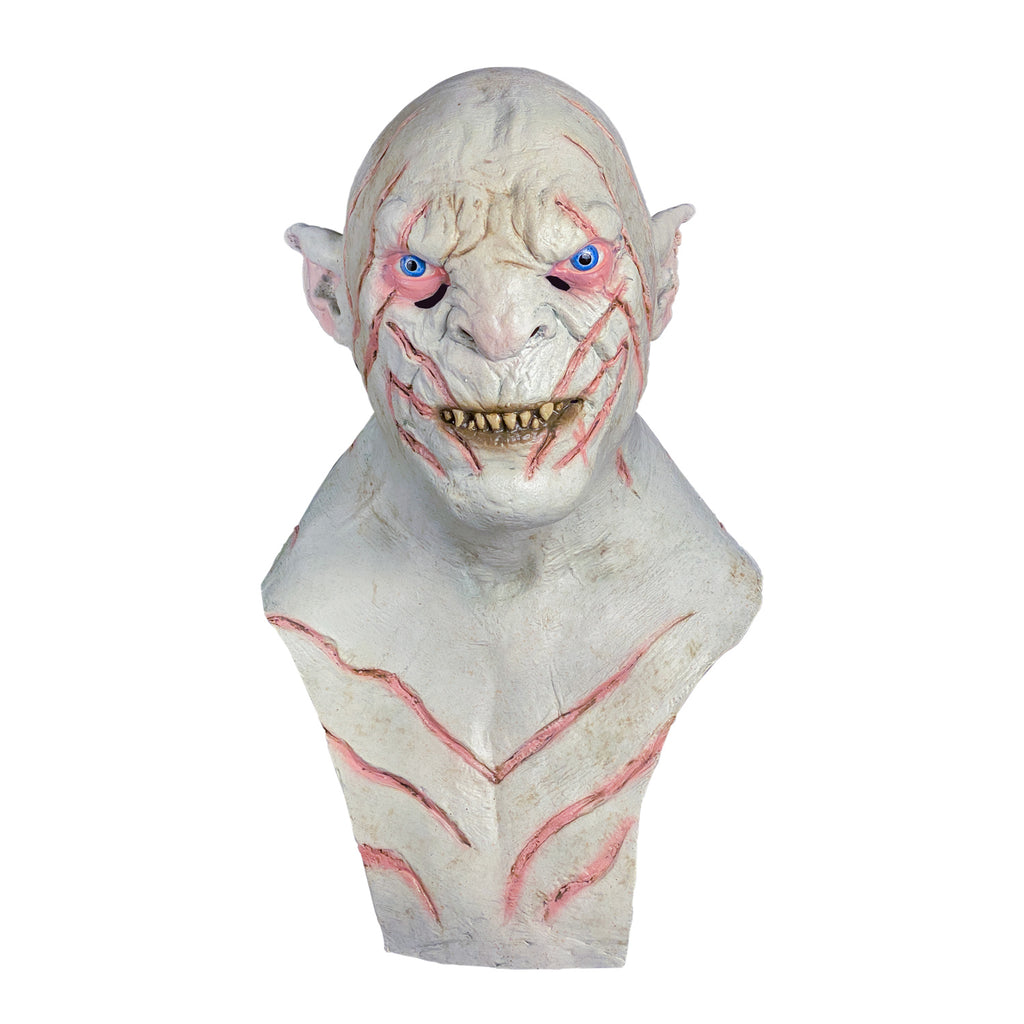 Mask, head, neck and chest, front view. Orc, bald, white flesh, pointed ears, pink-rimmed blue eyes, sharp yellow teeth in mouth, dark pink stripes on head, face and chest.