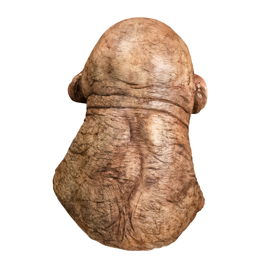 Mask, head and neck, back view. Troll, bald, wrinkled and dirty tan skin. Small ears. Thick neck, wrinkles at base of head.