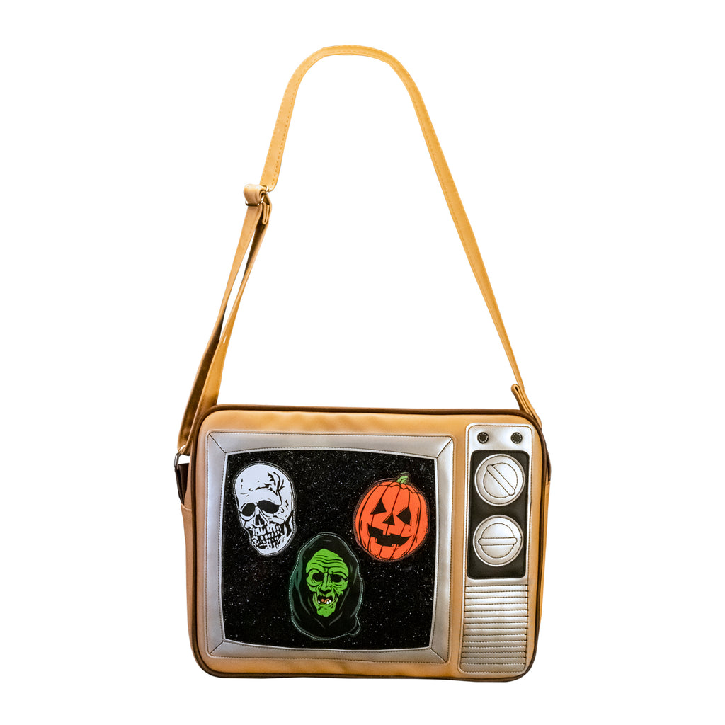Front view Bag,  made to look like a vintage TV with knobs.  Static on the screen with skull, jack o' lantern and witch faces, tan with strap.