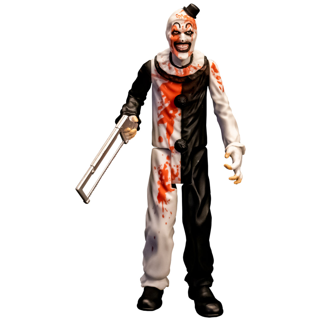 Terrifier, 5 inch figure, front view, with bloody feature.  Evil grinning clown face with tiny black top hat, black and white, jumpsuit, ruffle at neck, fingerless white gloves, black shoes. holding saw in right hand. Bloody feature on head, chest shoulder and leg.