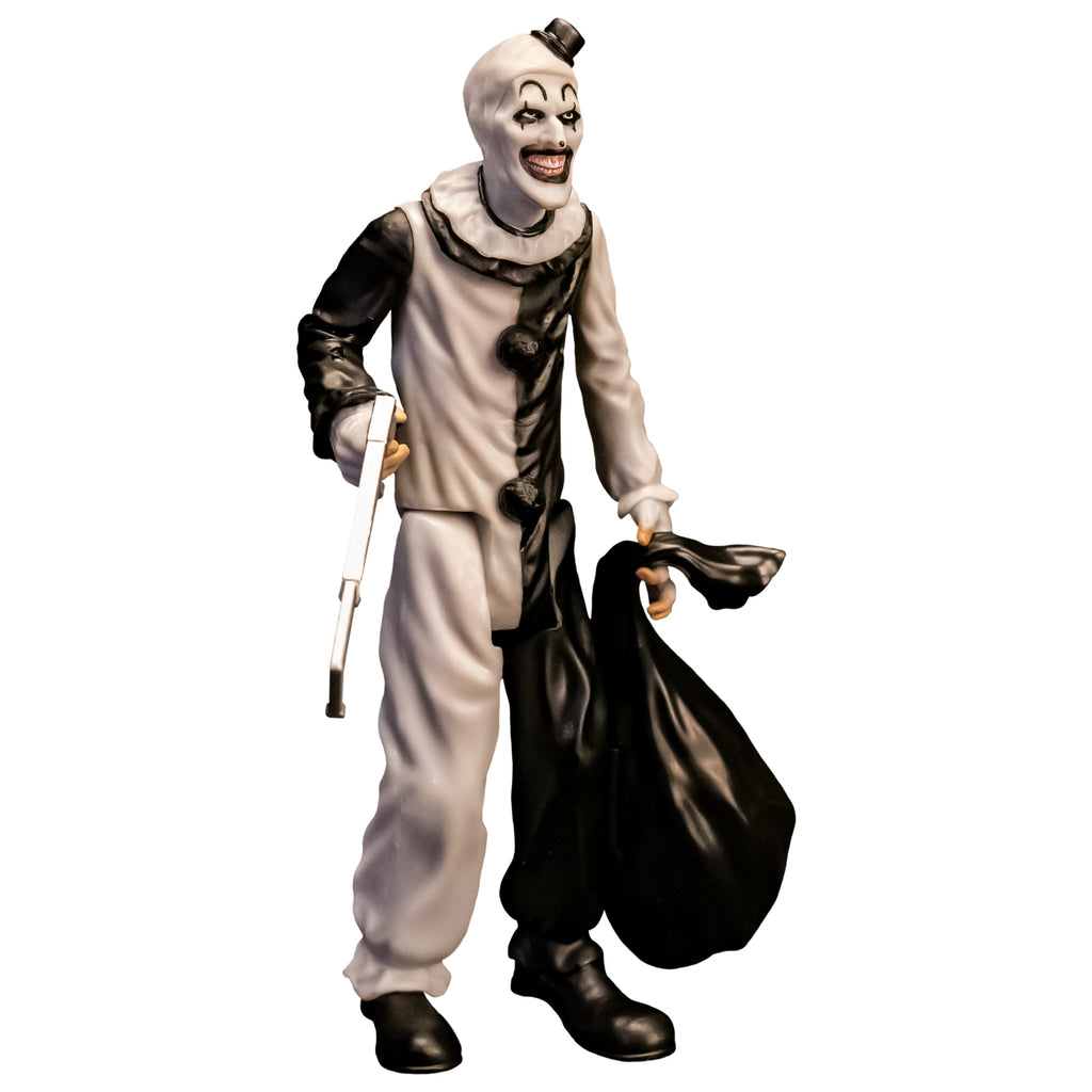 Terrifier, 5 inch figure, right side view. Evil grinning clown face with tiny black top hat, black and white, jumpsuit, ruffle at neck, fingerless white gloves, black shoes. holding saw in right hand, black trash bag in left hand.