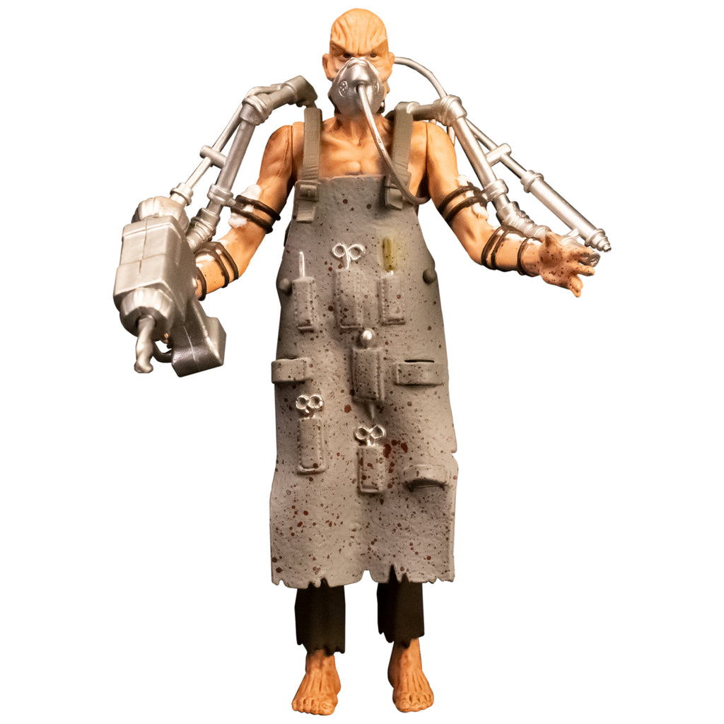 Action figure, front view. Bald man with wrinkled skin, wearing oxygen mask, gray apron with pockets holding medical instruments, shirtless, brown tattered pants, bare feet. Silver drill tools attached to both arms with black straps. 
