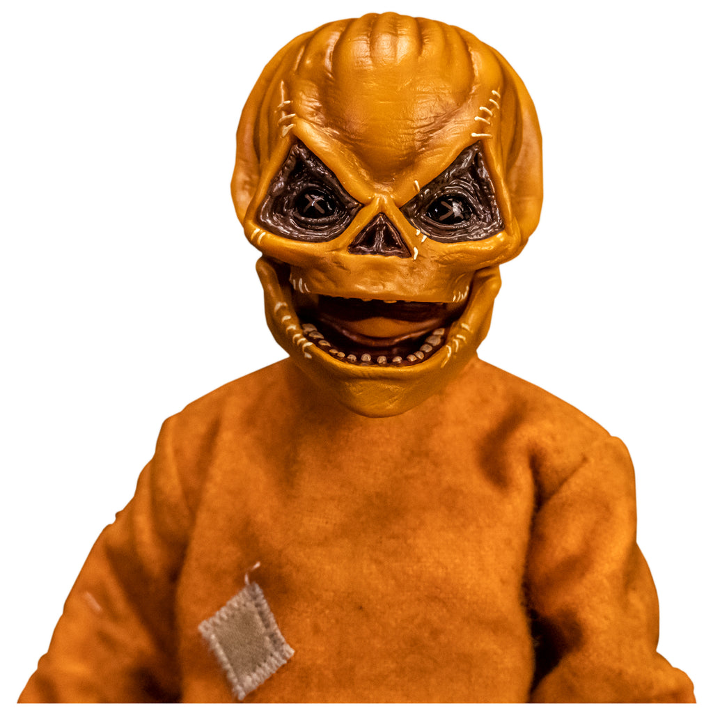 Front view. Close up of upper body and head of Trick 'r Treat Sam 1/6 scale figure with Sam Unmasked head. Head is Skull-like jack o' lantern face, stitches above eyes and sides of mouth, mouth open in grin. Wearing orange footy pajamas
