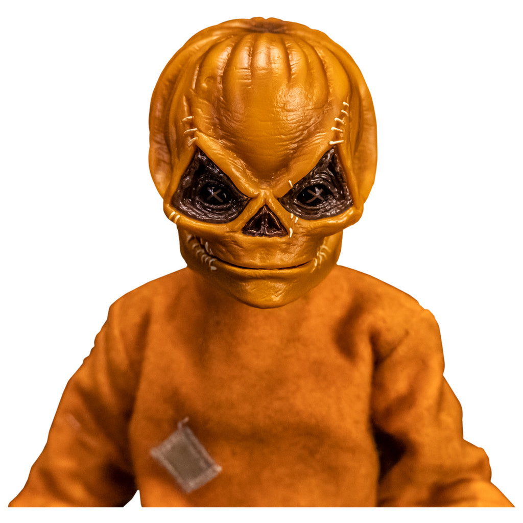 Front view. Close up of upper body and head of Trick 'r Treat Sam 1/6 scale figure with Sam Unmasked head. Head is Skull-like jack o' lantern face, stitches above eyes and sides of mouth, mouth closed in grin. Wearing orange footy pajamas