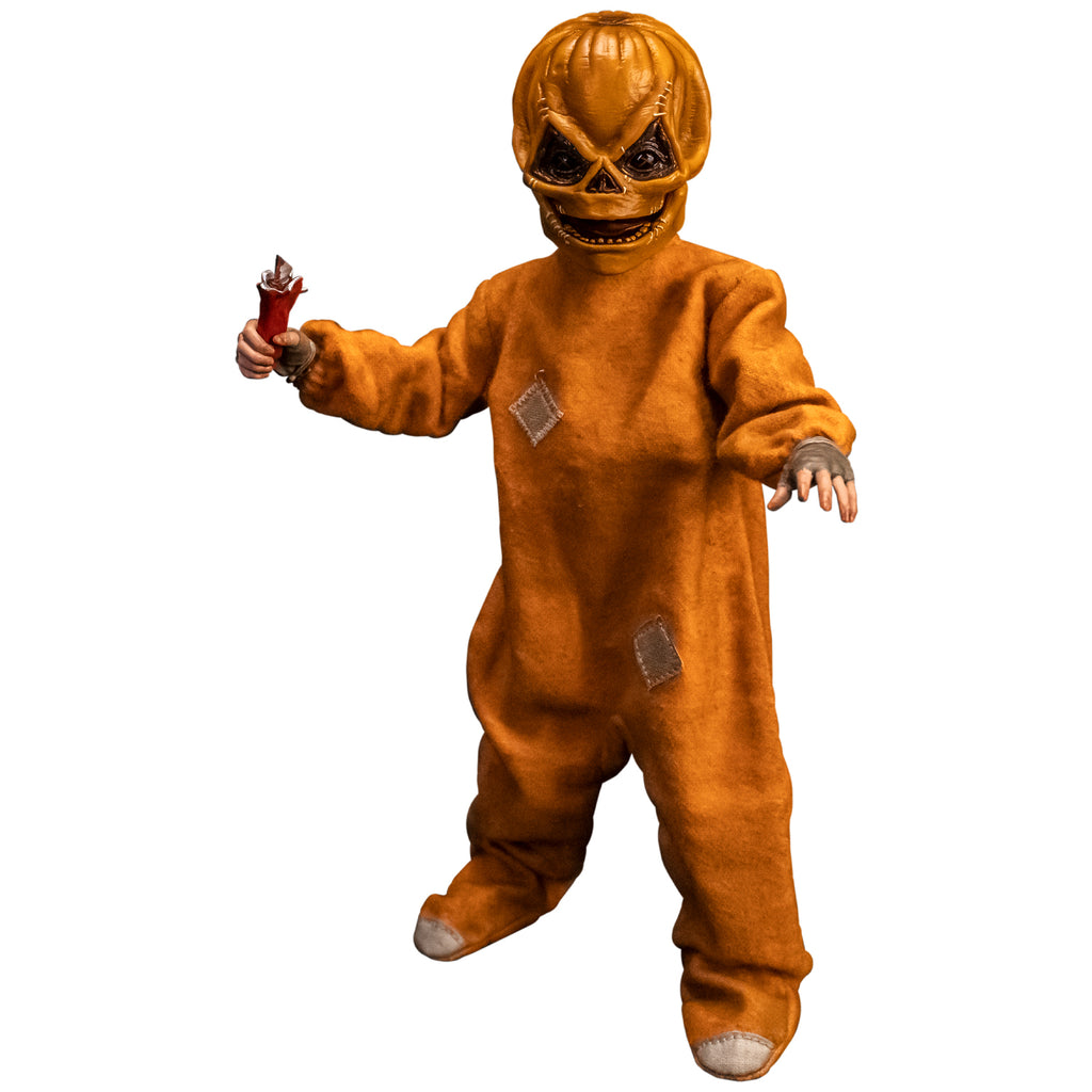 Trick 'r Treat Sam 1/6 scale figure with Sam Unmasked head.  Head is Skull-like jack o' lantern face, stitches above eyes and sides of mouth, mouth open in grin.  Wearing orange footy pajamas, brown fingerless gloves. Holding Hollie-ho bar razor lollipop prop in right hand.