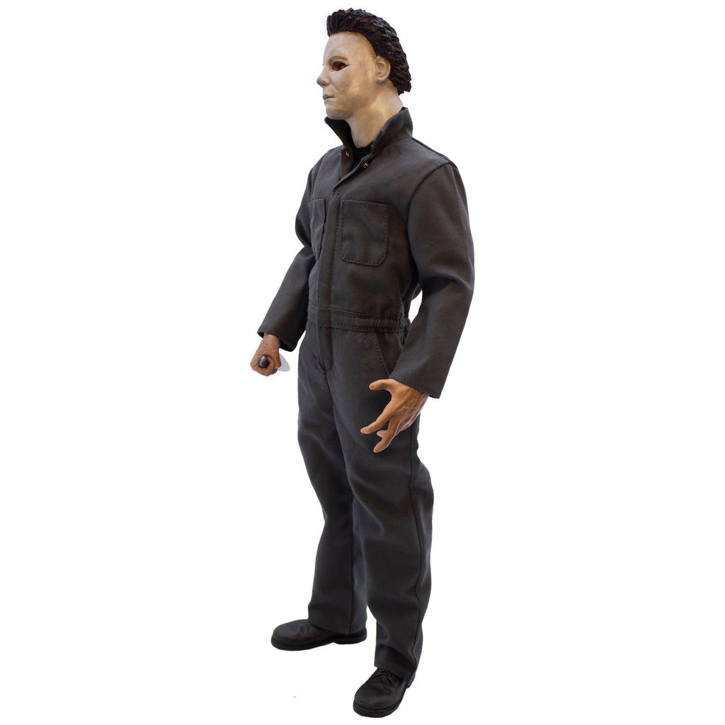 Left side view. Halloween H20 Michael Myers 12" figure. White mask brown hair, wearing dark coveralls, black boots, holding butcher knife in right hand.