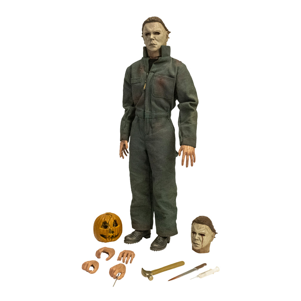 Halloween II Michael Myers 12" figure.  Pale mask brown hair, wearing dark coveralls, black boots, standing over additional accessories, Jack o' lantern 4 hands, weapons, additional head with blood tears