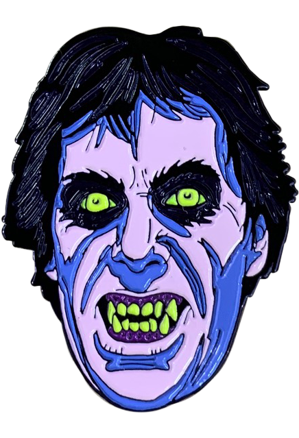 Enamel pin.  Blue and white face, black hair. black rimmed bright green eyes.  Snarling mouth, dark pink gums, bright green teeth and fangs.