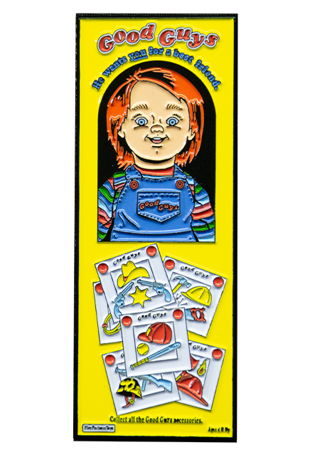 Enamel pin.  Illustration of Good Guys Doll in yellow box with window, red hair, blue eyes, smiling, wearing blue, red, green and white striped shirt under blue overalls with text Good Guys printed on pocket.  Test Reads Good Guys, in red, He wants you for a best friend in blue.  illustrations of additional accessories below window in box.