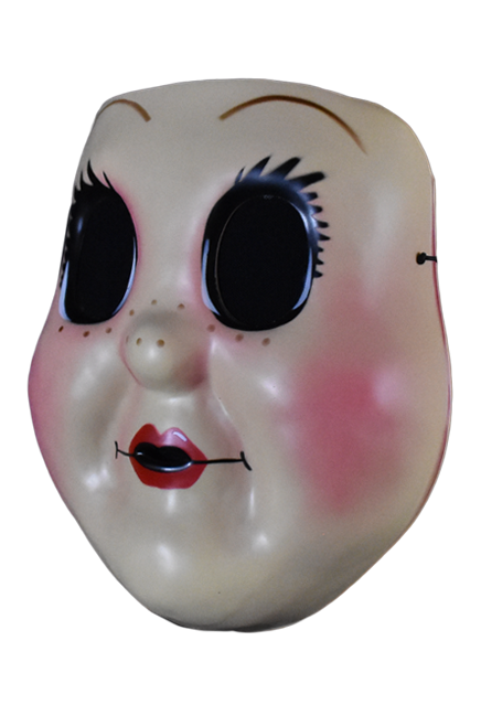 Plastic face mask, left view. Dollface, large empty black eyes with spiky eyelashes. Thin brown eyebrows. Freckles on nose and cheeks, smiling mouth with small red lips. Plump pink cheeks.