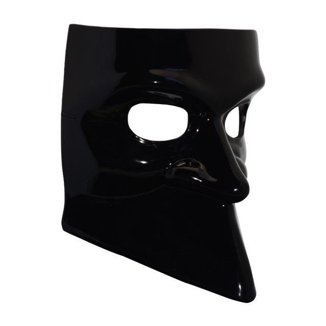 Right side view. Shiny black plastic face mask, nondescript features, smooth where mouth would be.