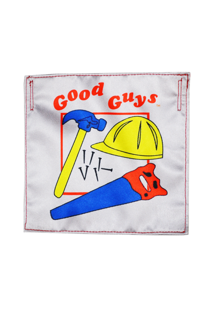 Good Guys Doll bib prop.  White square, Red text reads Good Guys, illustrations of blue hammer with yellow handle, yellow construction helmet, blue saw with red handle