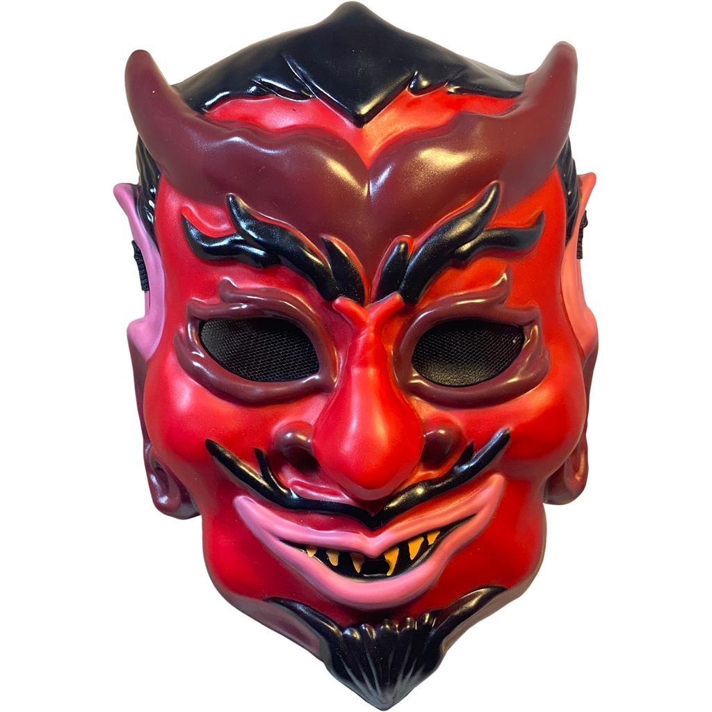 Plastic mask, front view. Red devil face, black hair, eyebrows, moustache and goatee. Maroon horns, outlines around eyes, nostrils and earlobes. Pink upper ears and lips. Pointed yellow teeth. 