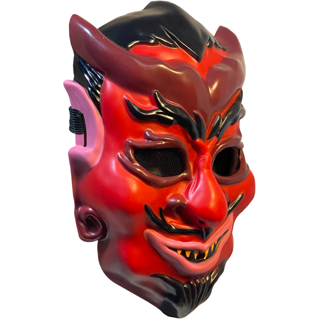 Plastic mask, right side view. Red devil face, black hair, eyebrows, moustache and goatee. Maroon horns, outlines around eyes, nostrils and earlobes. Pink upper ears and lips. Pointed yellow teeth.