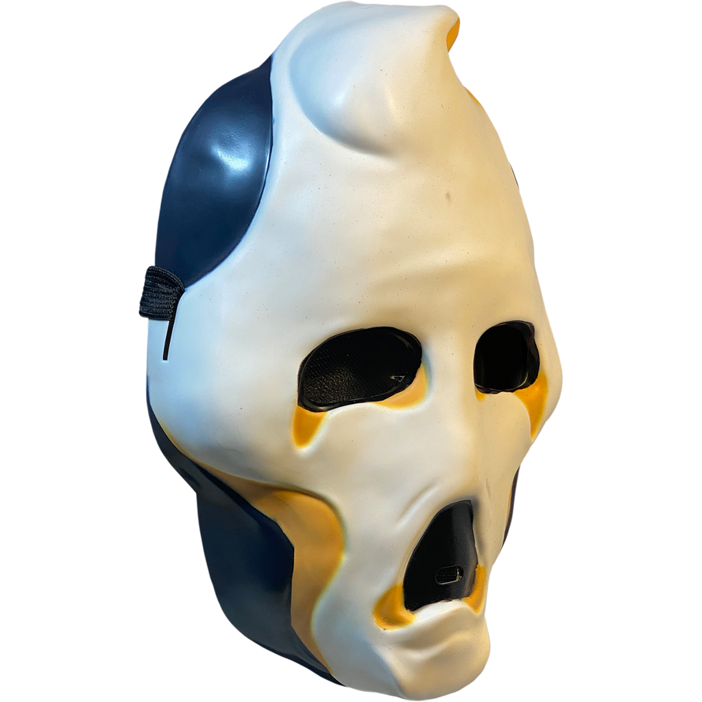 Plastic mask, right side view. White ghost face, black on sides of head and jaw. Black eyes and open moaning mouth. Yellow at tip of pointed head, around bottom of eyes and mouth and below cheeks.