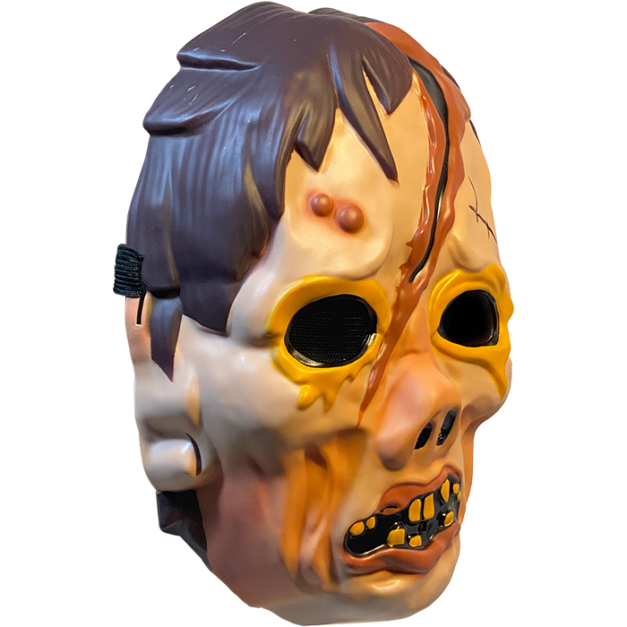 Plastic mask, right side view. Zombie face. Brown hair. Yellow rimmed black eyes. Large gash on forehead to bridge of pug nose. Misshapen mouth with pink lips and sparse yellow teeth.