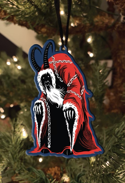 Metal ornament.  Krampus in red cloak, wrapped in chains.