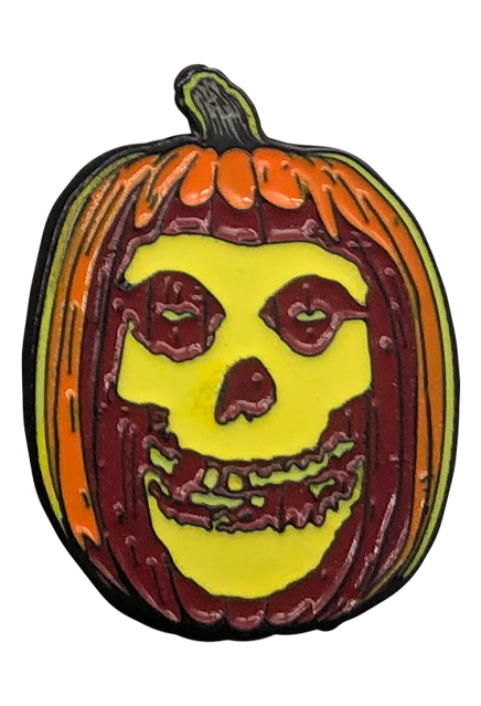 Enamel pin. Orange jack o' lantern with Misfits Fiend skeleton face on it.