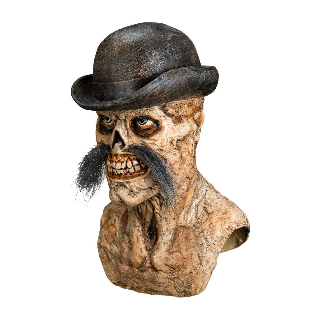 Left side view. Dead Eye Mask, head neck and upper chest. Skeletal grinning face with rotten flesh, grotesque teeth and gums. Blue eyes, bushy moustache, wearing a black Bowler hat.