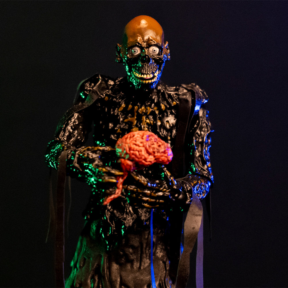 1/6 scale Tarman figure, close up of Tarman holding a pink brain. Bare skull, grinning mouth, tar covered body, ribs showing through dripping tar.