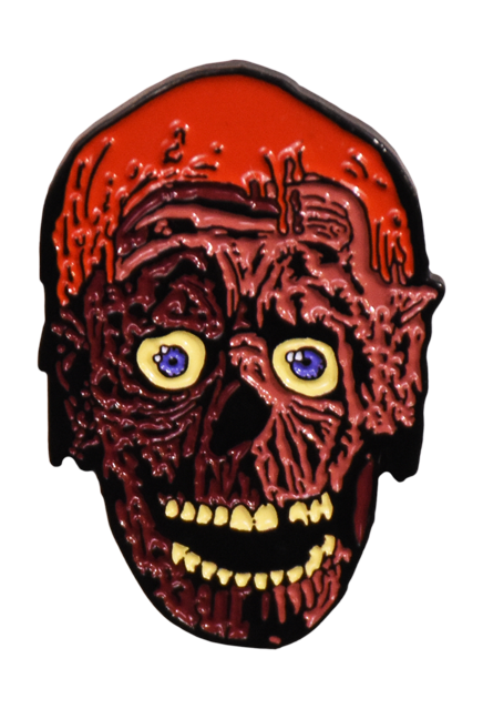 Enamel pin. Tarman, skeletal face, sparse hair, covered in brown tar. Blue eyes. Mouth open, many white teeth