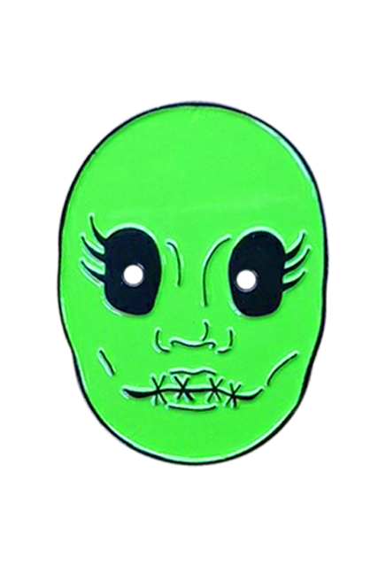 Enamel pin. Illustration, bright green face, large black eyes with 3 eyelashes on the sides, 4 black x stitches across lips.