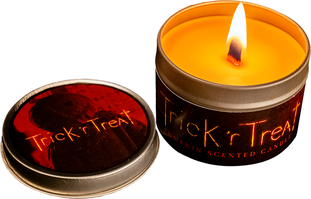 Orange candle in silver metal tin.  Wide flat wick, lit.  Orange text on tin reads Trick 'r Treat pumpkin scented candle.  Lid of tin shows orange toned Sam in background, orange text in foreground reads Trick 'r Treat.