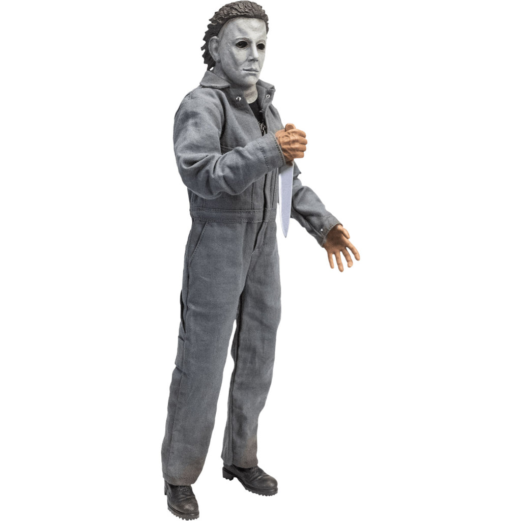 Right side view. Halloween 6 Michael Myers 12" figure. White mask brown hair, wearing coveralls, black boots, holding butcher knife in right hand.