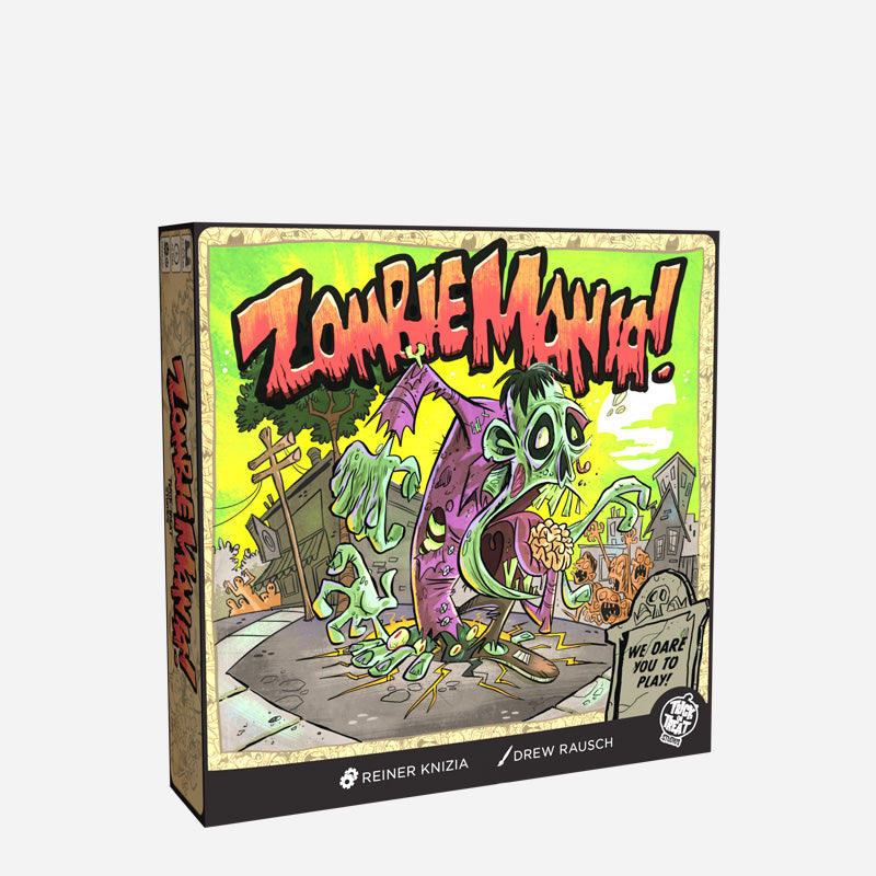 Product packaging, front. Box, colorful illustration of cartoonish zombies, bright green background. Orange text reads Zombie Mania! Black text on gray gravestone reads We dare you to play!  White text at bottom of box reads Reiner Knizia, Drew Rausch.  White Trick or Treat Studios logo.   